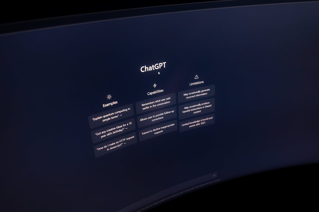 services-01 Close-up of a computer screen displaying ChatGPT interface in a dark setting.