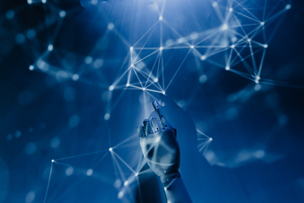 services-img A robotic hand reaching into a digital network on a blue background, symbolizing AI technology.